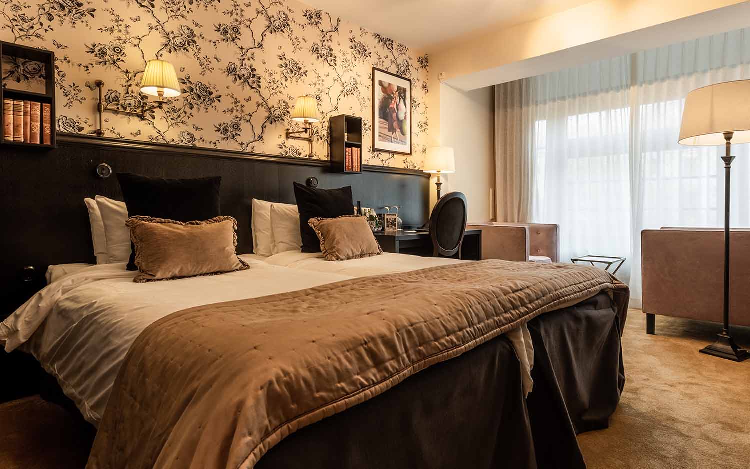 Bellora room corner with reading chair and soft lighting