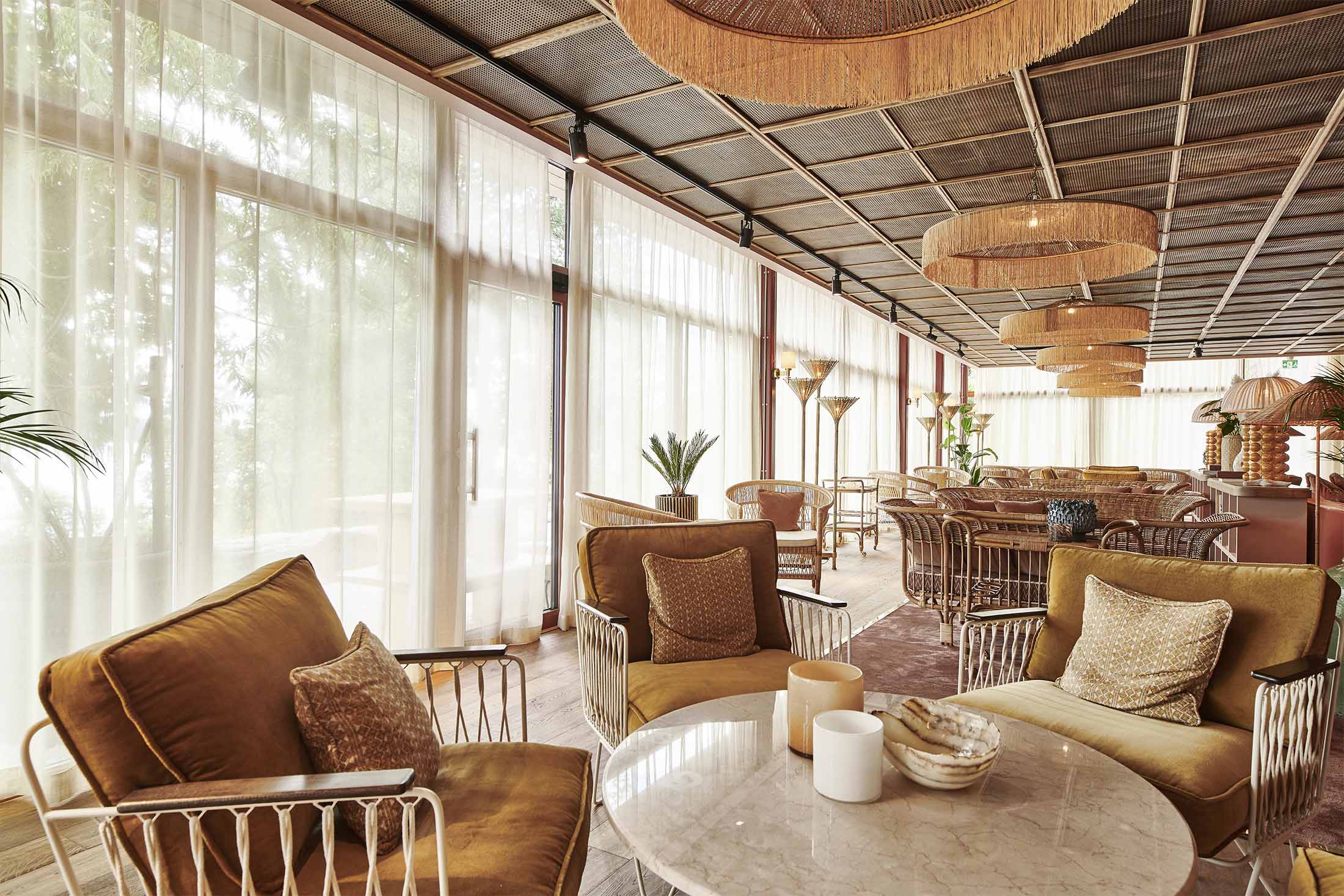 Ellery Beach House resort grounds with trees and waterfront walkways