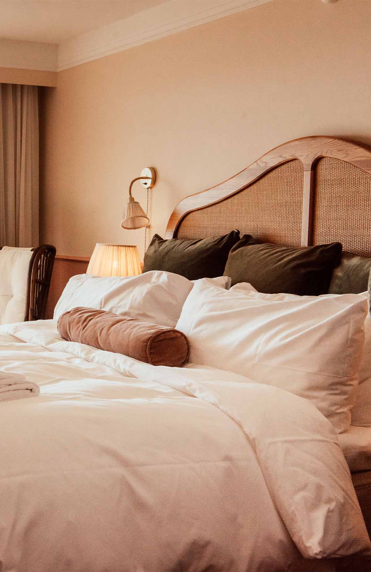 Comfortable bed and bedroom in a guest room at Falkenberg Strandbad