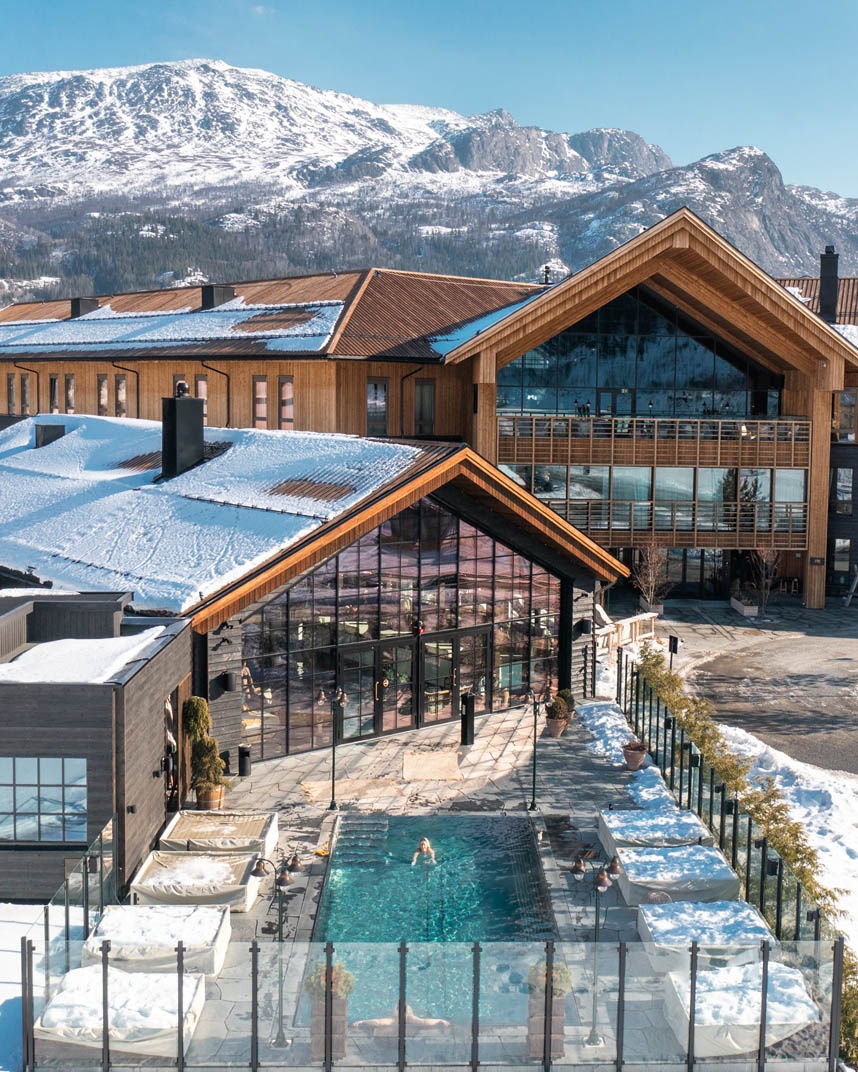 Outdoor pool surrounded by mountains at Fyri Resort Hemsedal