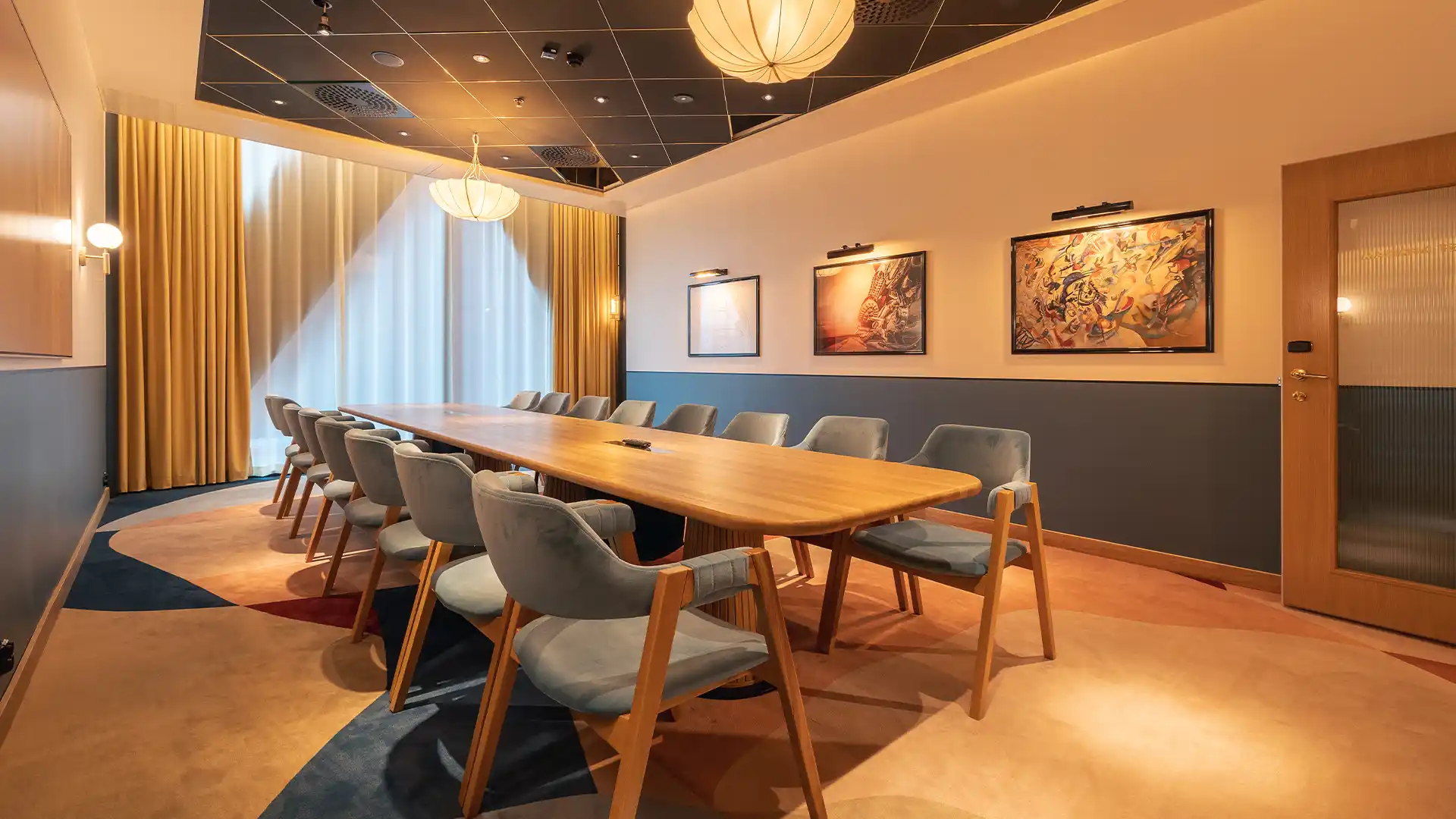 Conference room with presentation screen and attendees at Jacy'z