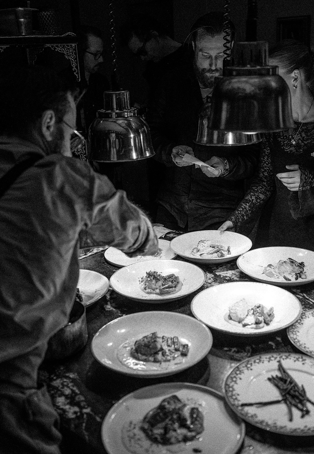 Open kitchen with chefs preparing dishes at Hotel Pigalle