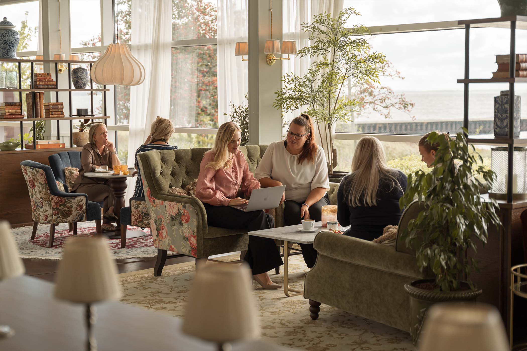 Guests relaxing on sofas at Ystad Saltsjobad resort lounge